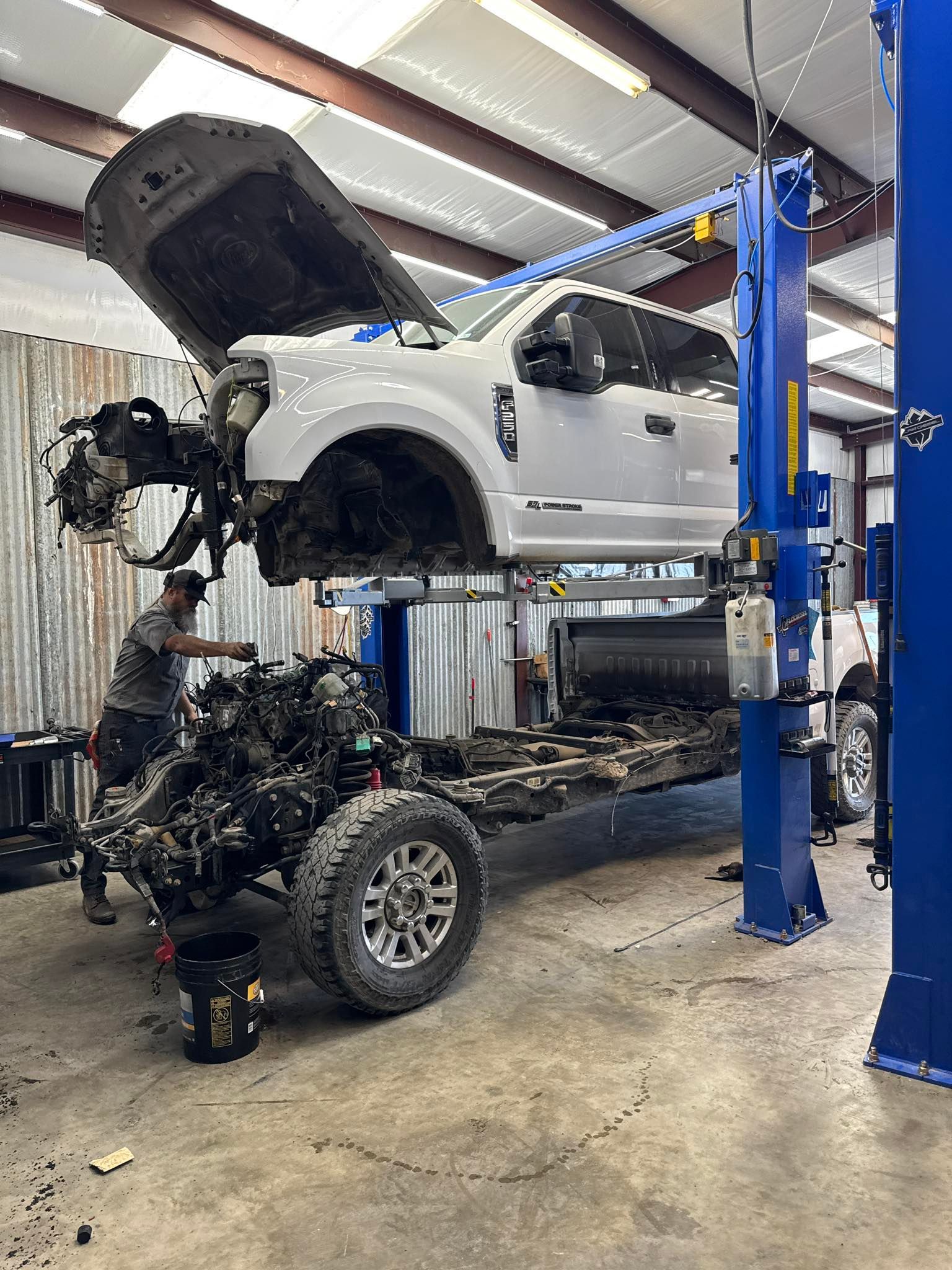 Mechanic Working on a White Truck | Flo Diesel Performance