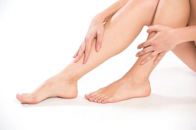 Woman holding her legs — Diabetic feet in Westborough, MA