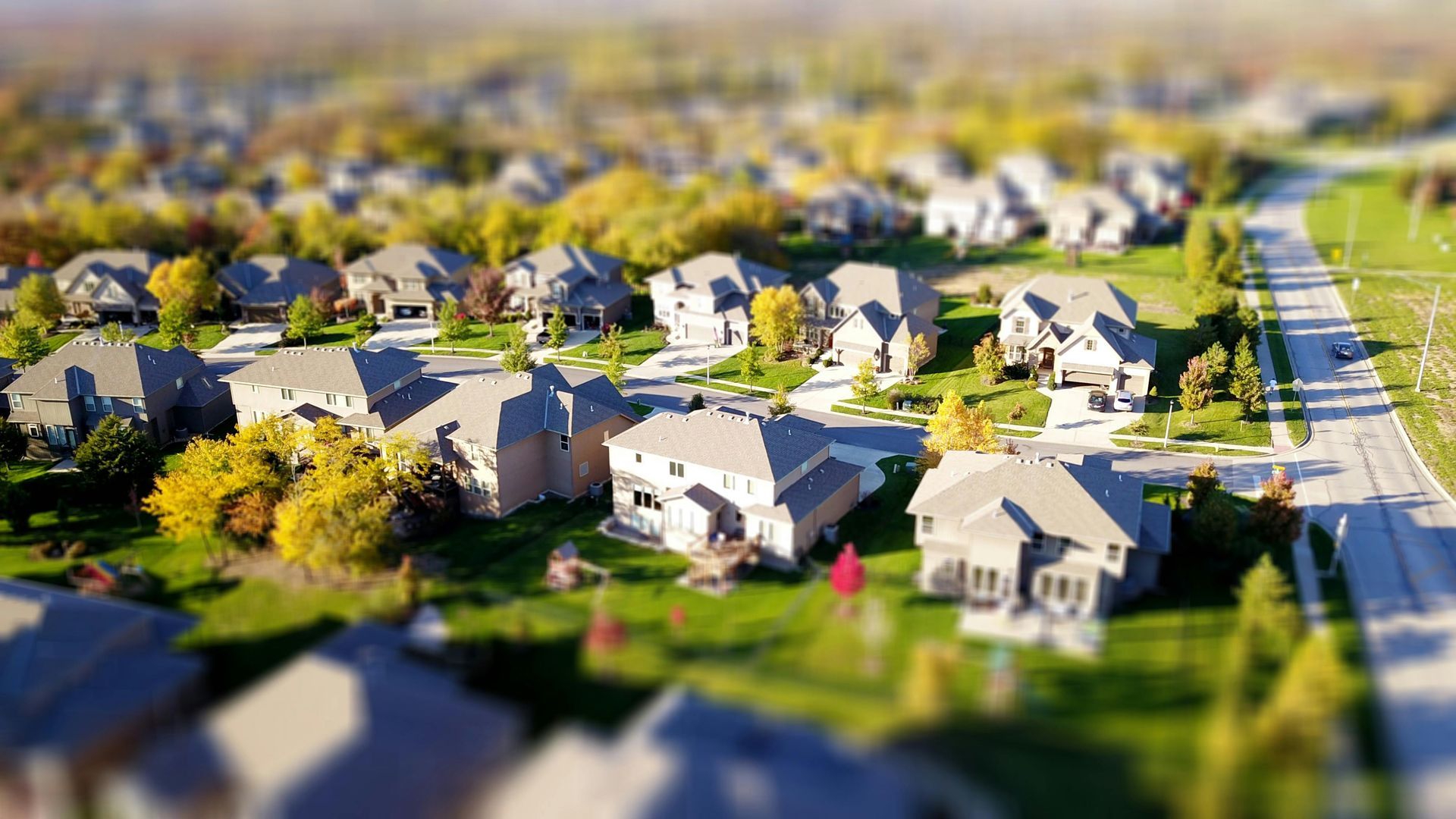 An aerial view of a residential neighborhood with lots of houses and trees.