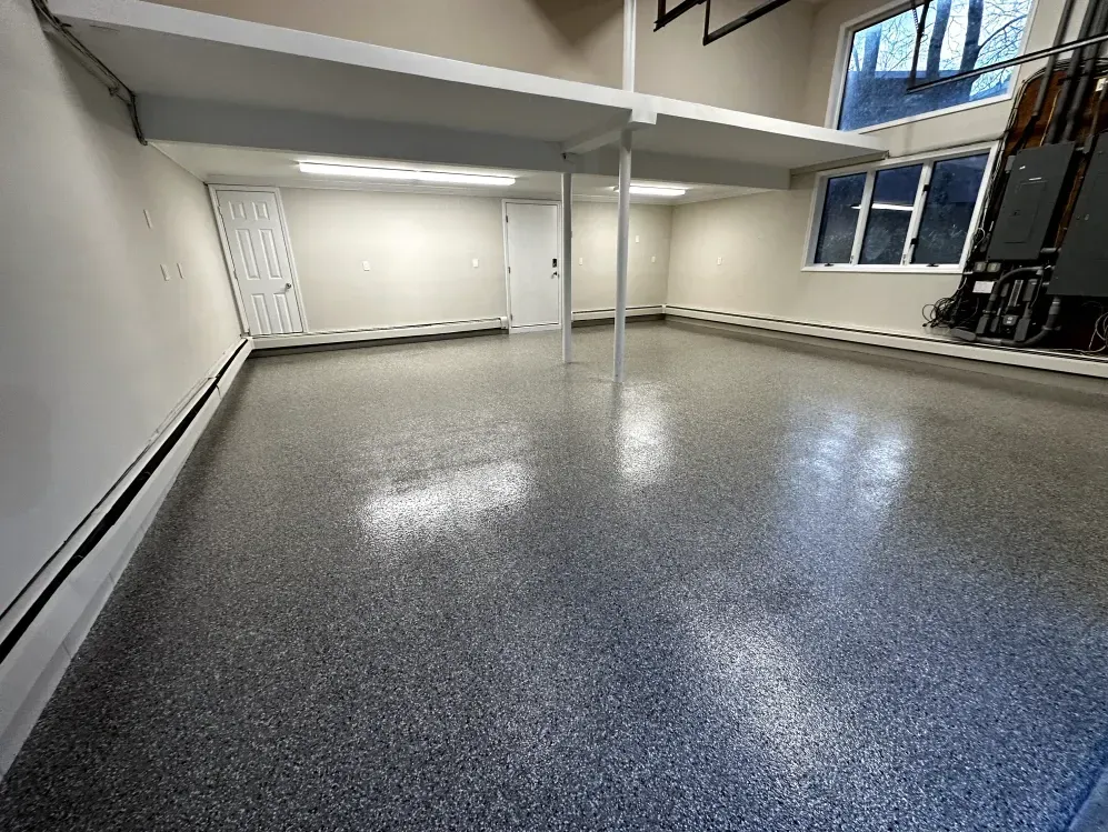Empty garage with epoxy floor and a built-in loft.