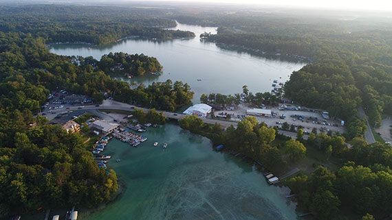 An aerial view of a lake surrounded by trees.