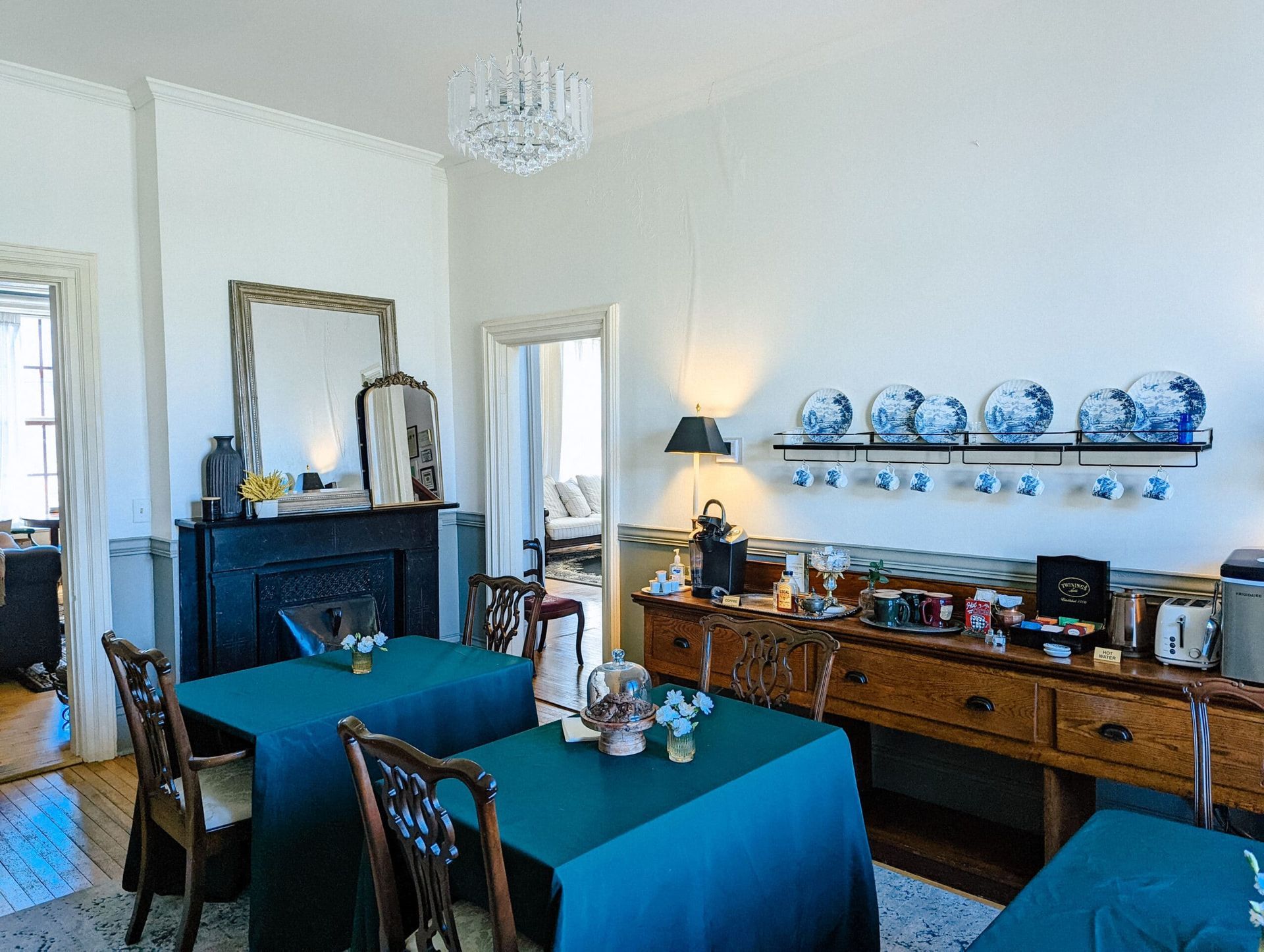 A dining room with tables and chairs and a fireplace