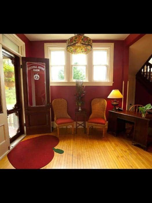 A room with red walls and chairs and a door that says school club