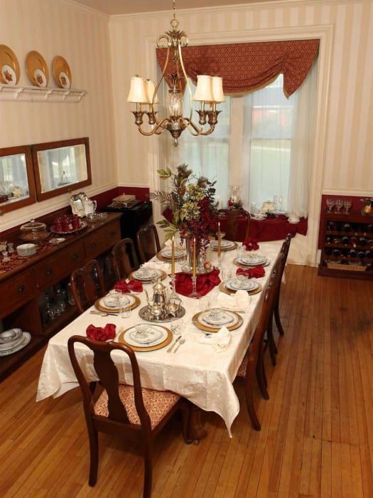 A dining room with a long table and chairs