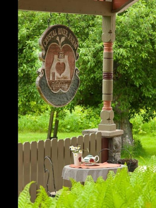 A sign for crystal river farms hangs above a table