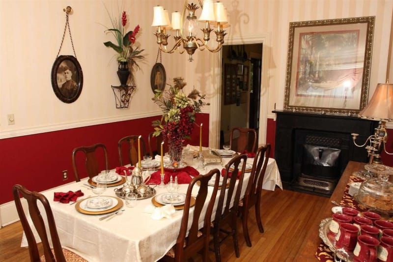 A dining room with a long table and chairs