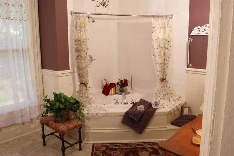 A bathroom with a bathtub and a window