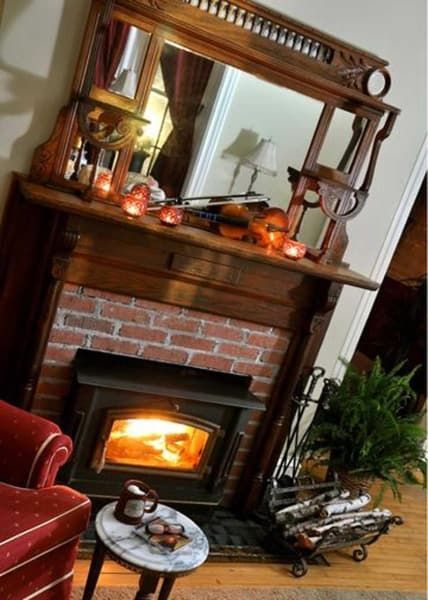 A living room with a fireplace and a mirror