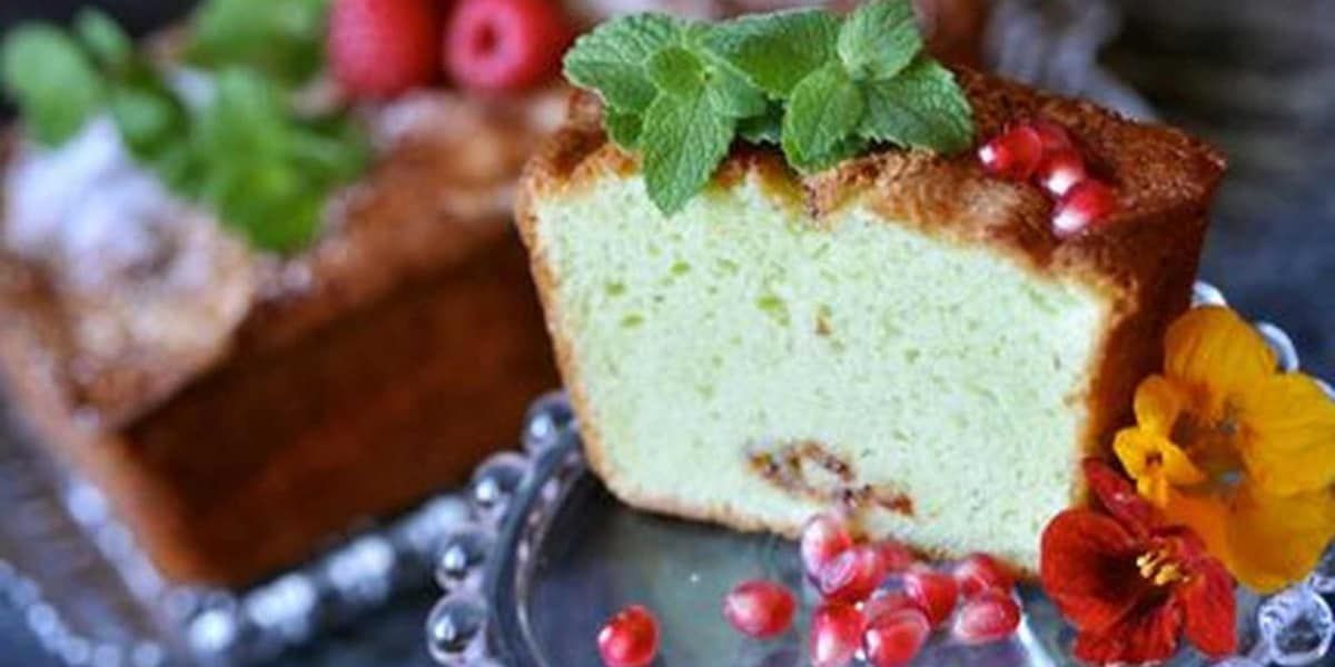A slice of cake is on a glass plate with flowers on it.