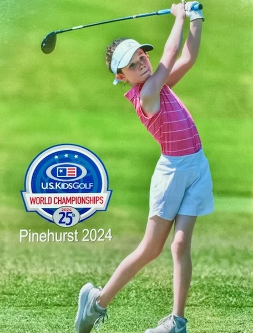 A young girl is swinging a golf club at the us kids golf world championships