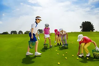 A group of children are playing golf on a golf course.