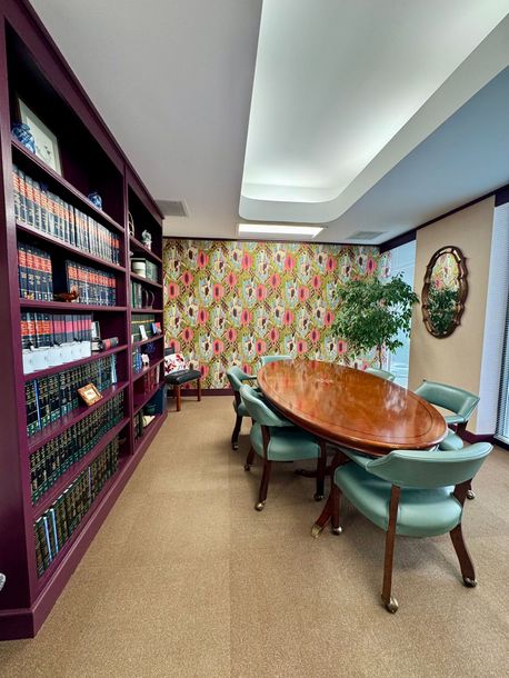 A room with a table and chairs in it.