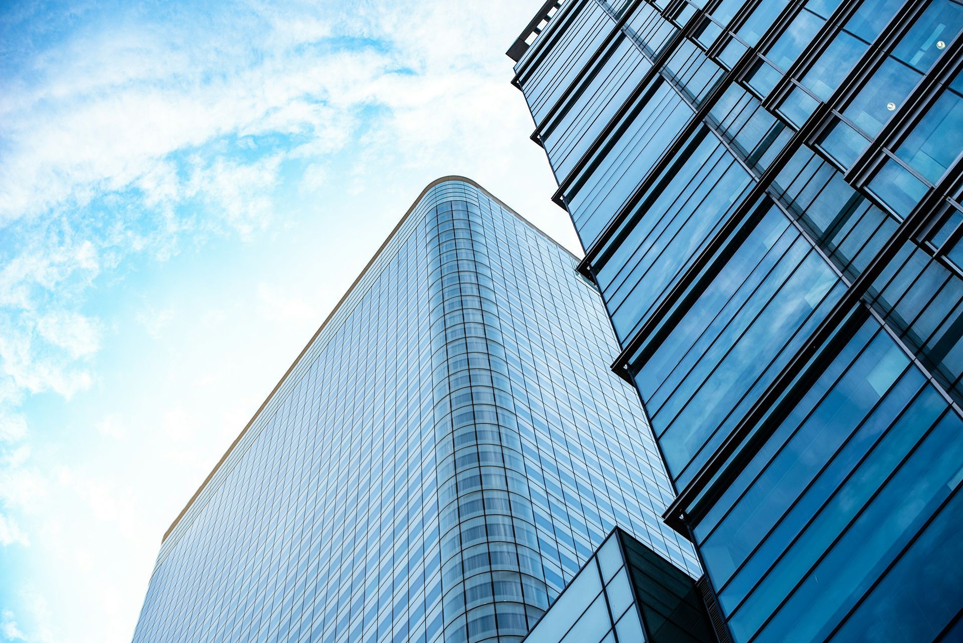 Looking up at a tall building with a blue sky in the background.