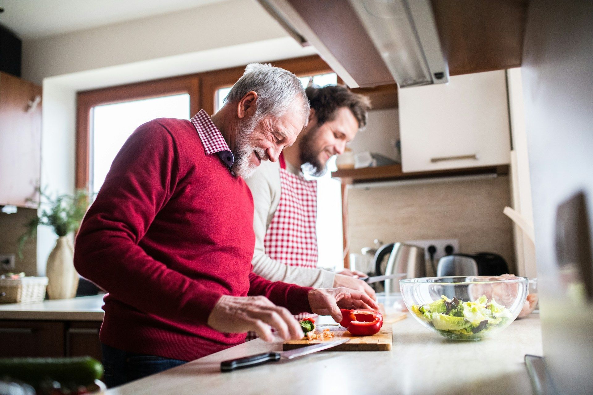 A father and son are preparing food in the kitchen.