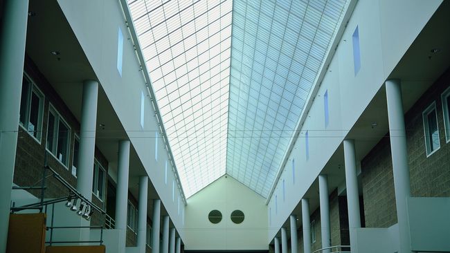 A very long hallway with columns and a skylight