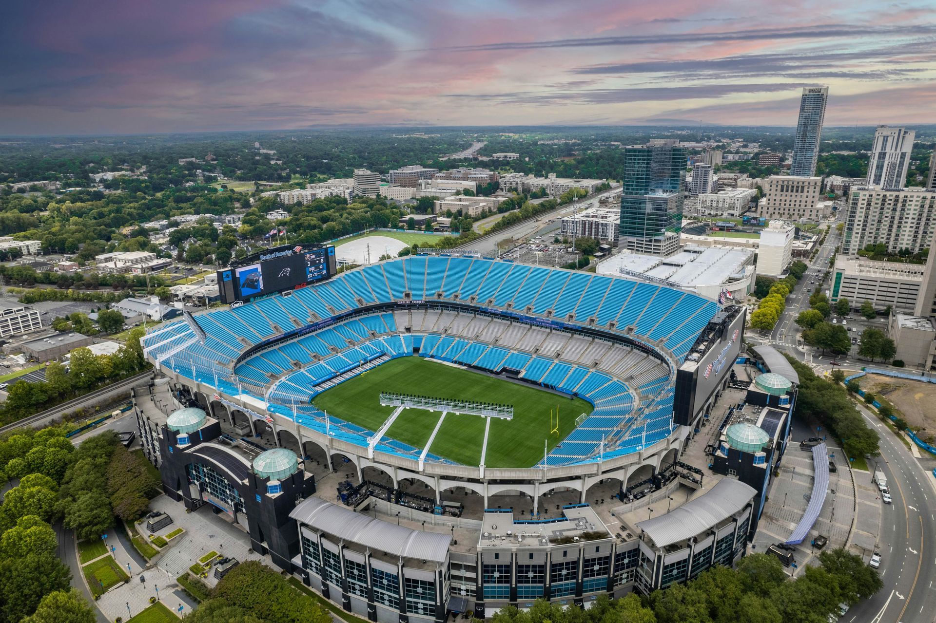 An aerial view of a football stadium in a city.