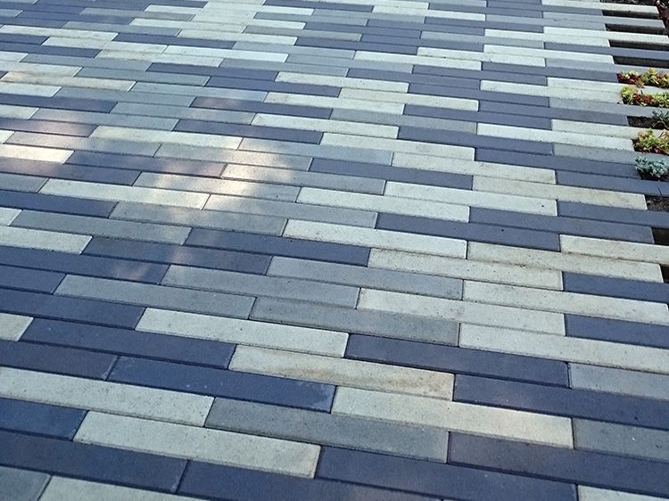 A black and white brick walkway with a diagonal pattern
