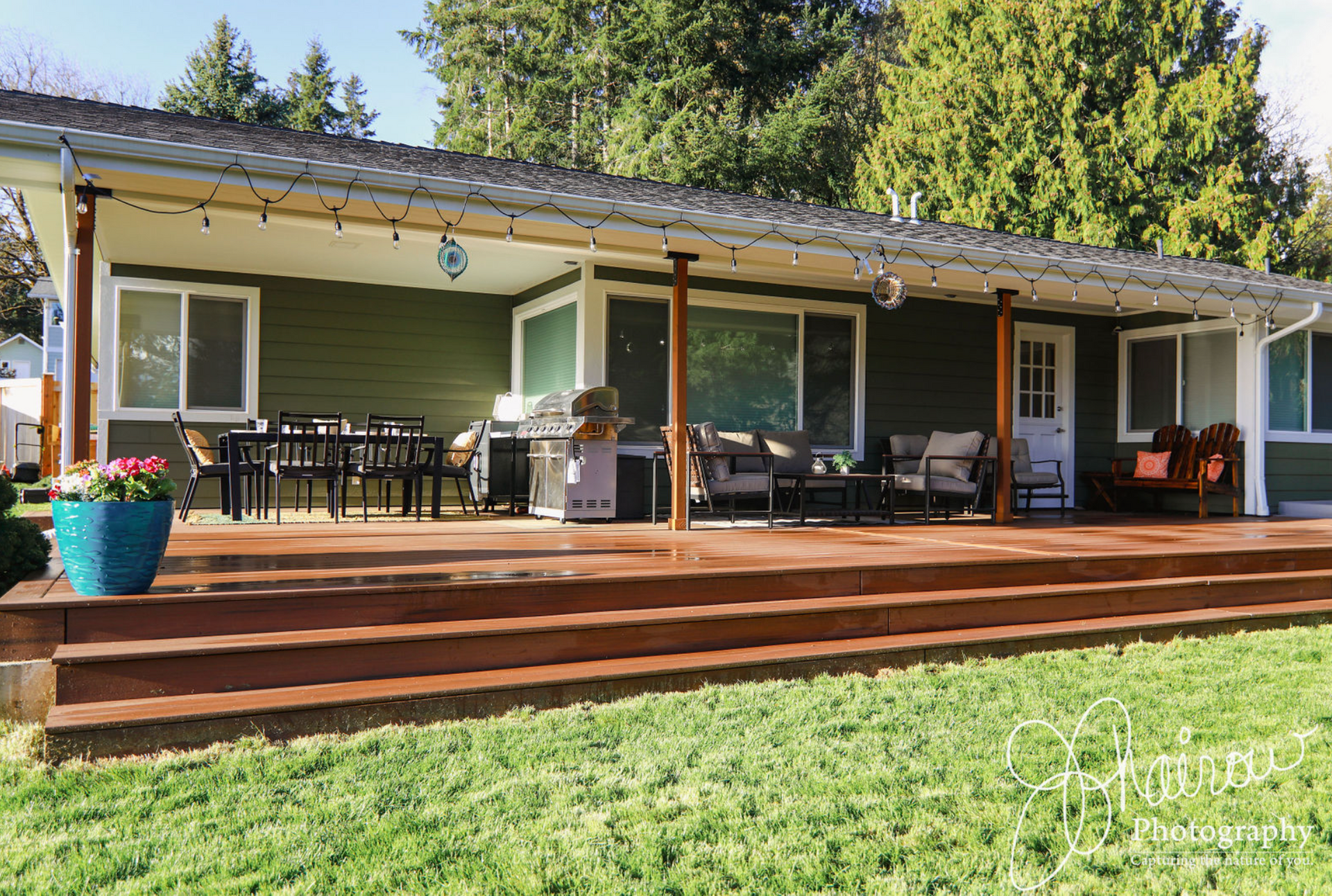 A house with a large deck and a covered porch.