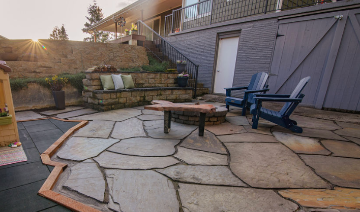 There is a fire pit in the middle of the patio.
