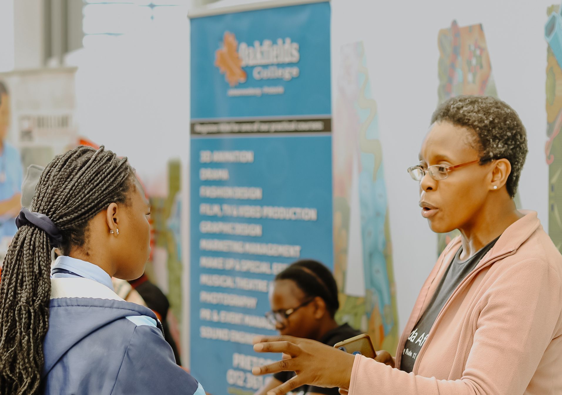 Oakfields College Teacher explains to a student at the Tshwane Regional Mall career expo