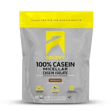 Ascent 100% Casein protein powder bag, chocolate flavor. Grey bag with yellow accents. Contains 25g protein, slow release, 0g sugar.