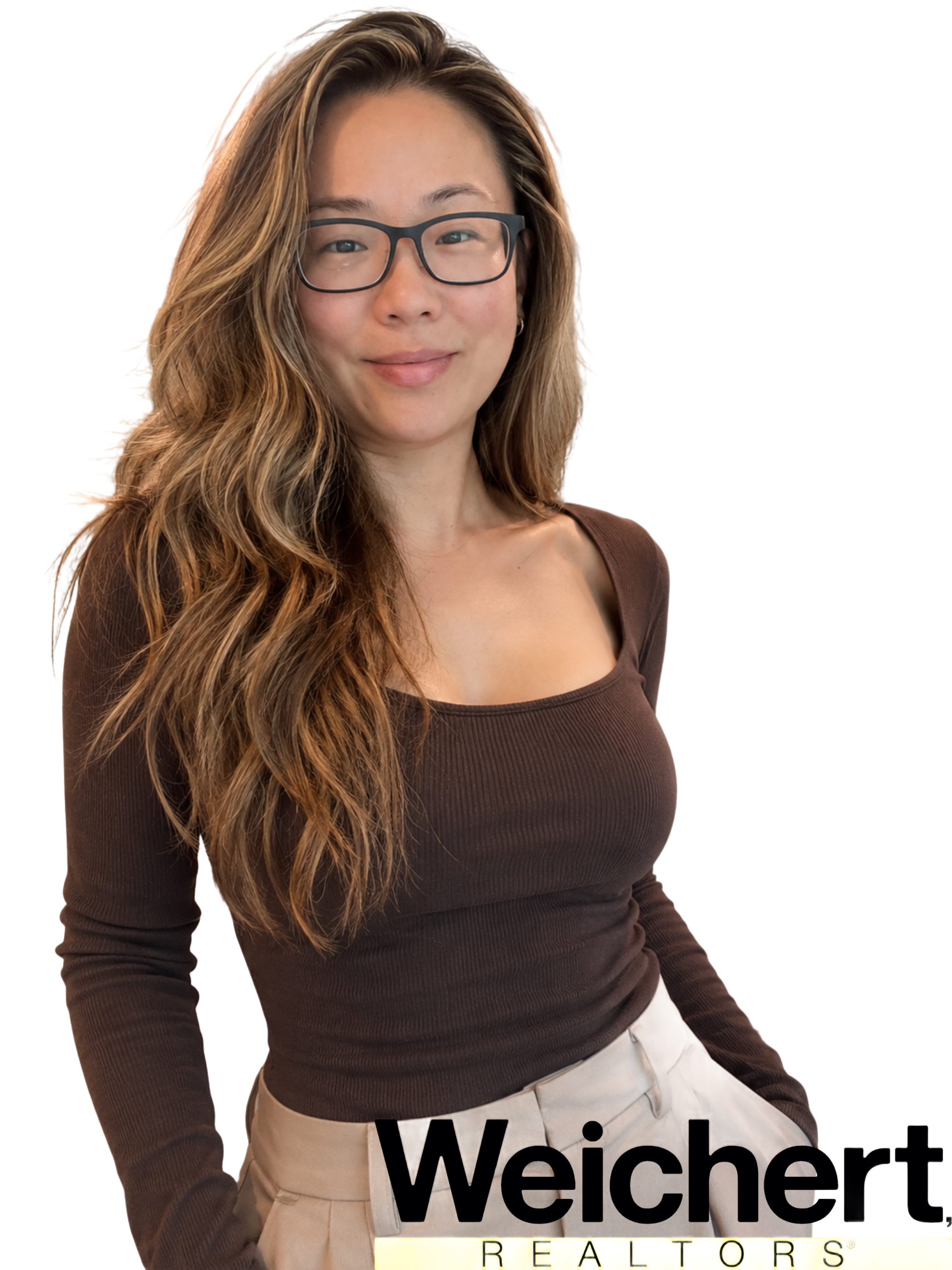 Woman with long wavy hair and glasses wearing a brown top beside a Weichert Realtors logo