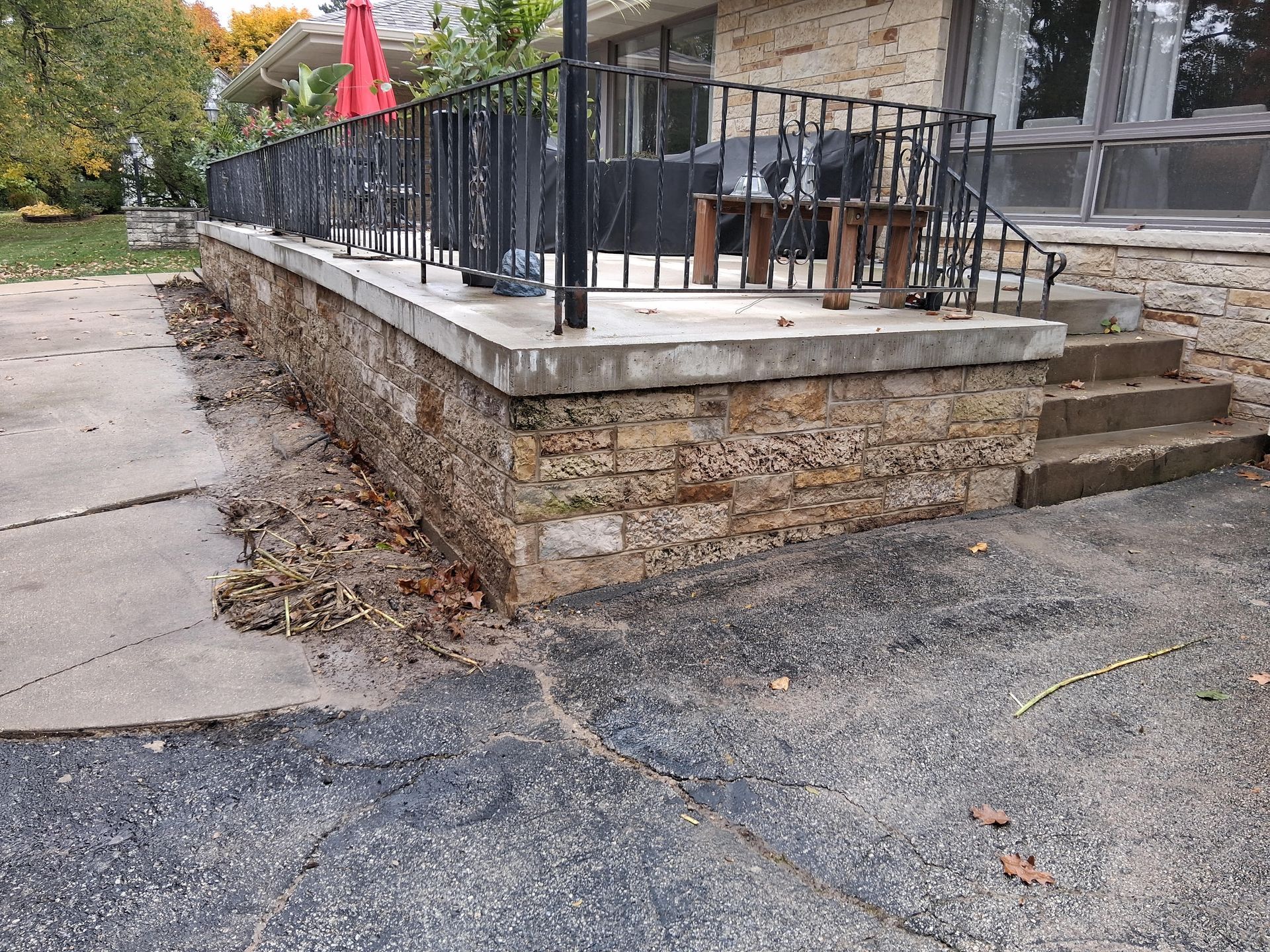 A white truck is towing a dump truck in a rocky area.