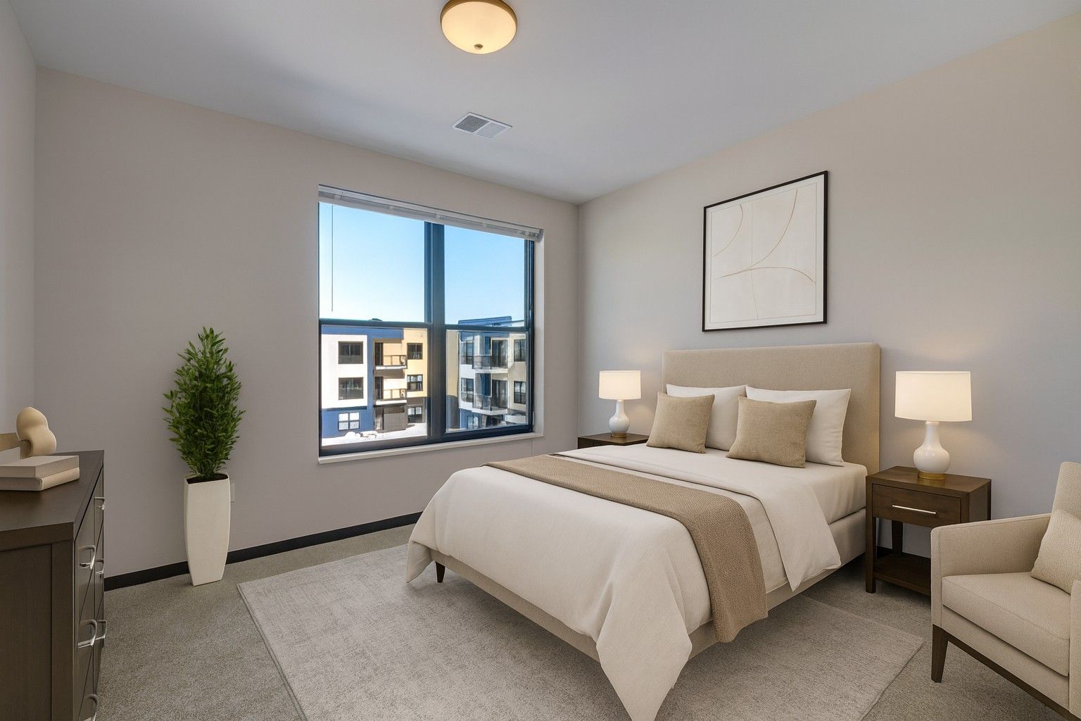 Bright modern bedroom with a bed, nightstands, window, chair, and potted plant.