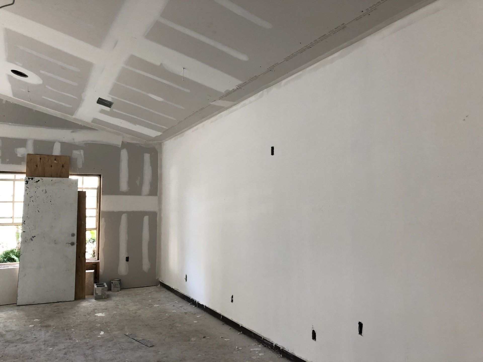 recreation room during remodel with new drywall after space had been stripped down to the studds