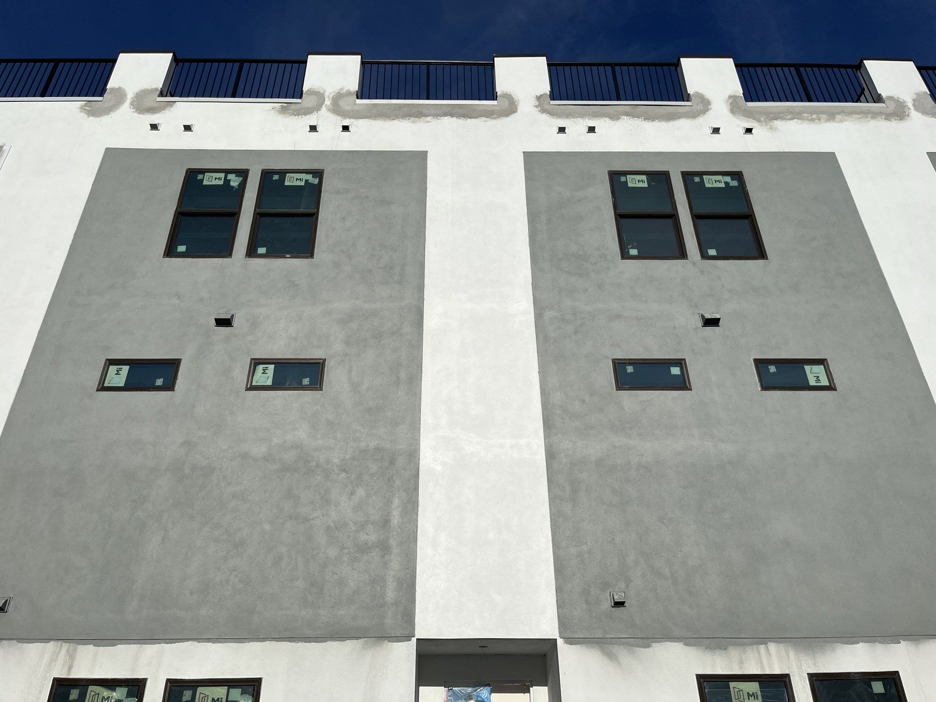 three store condos with stucco application along all exterior walls
