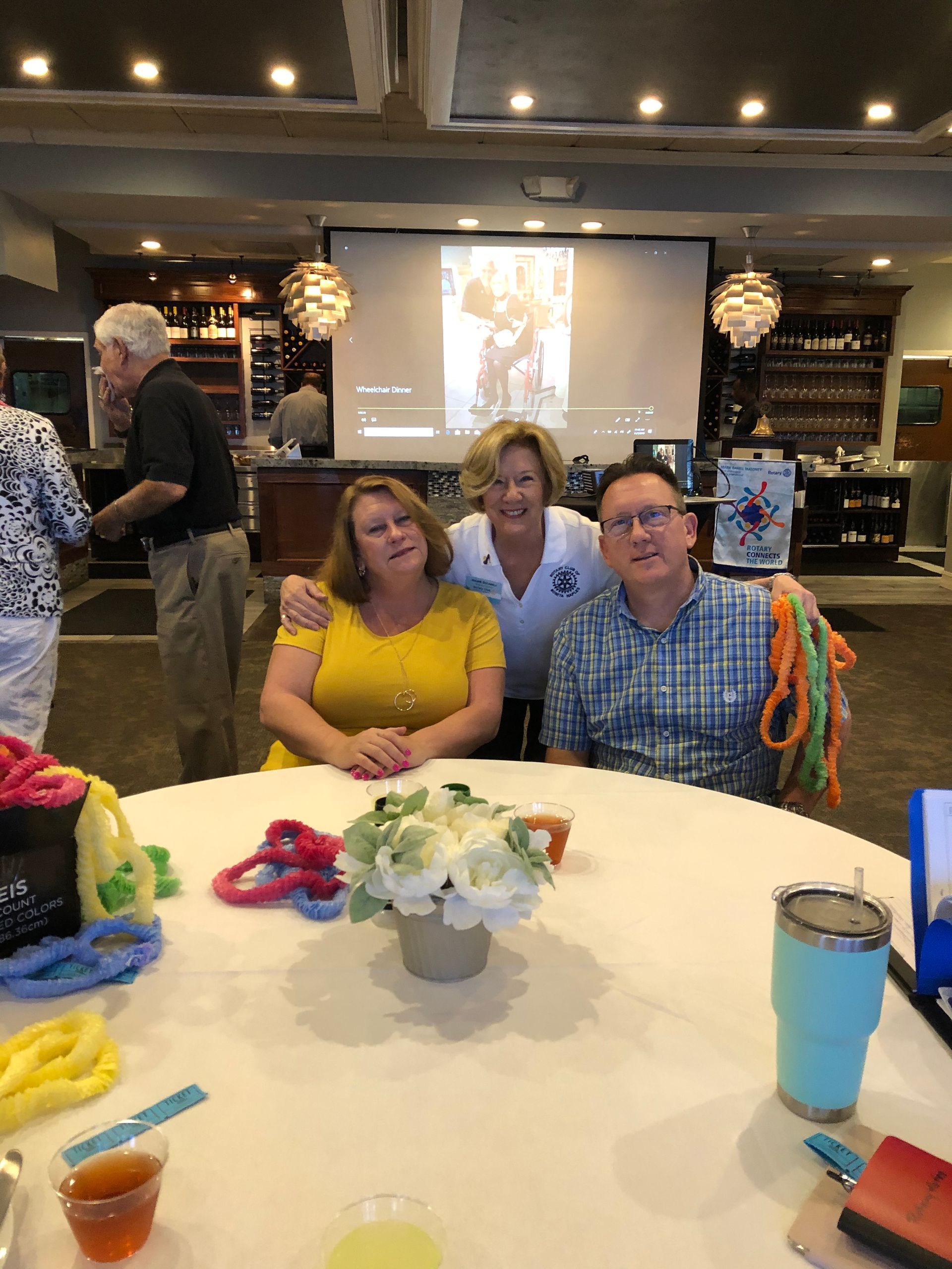 A group of people are posing for a picture at a table.