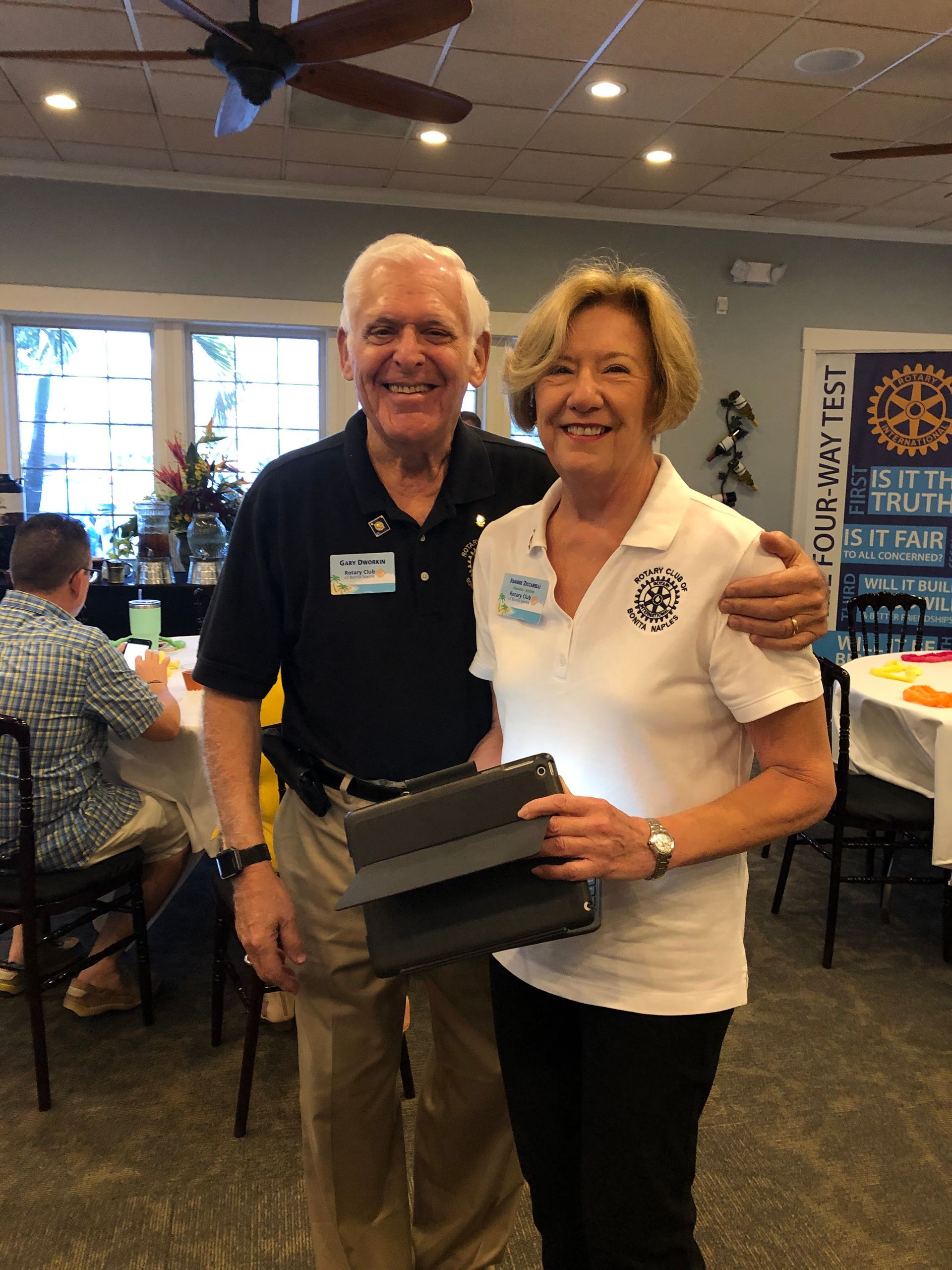 A man and a woman are posing for a picture in a room.