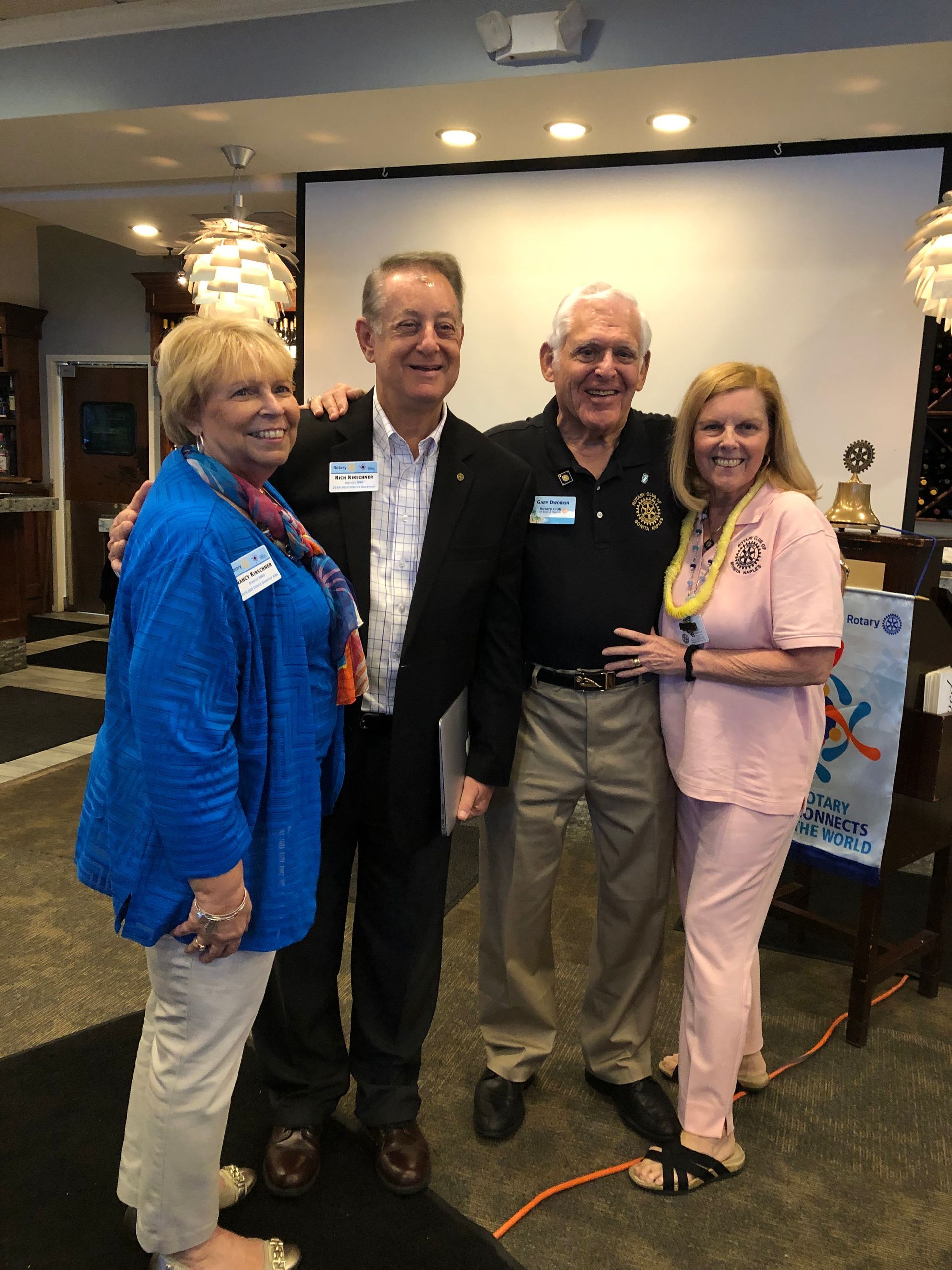 A group of people are posing for a picture in a room.