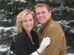 A man and a woman are posing for a picture in the snow.