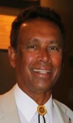 A man in a suit and tie is smiling for the camera.