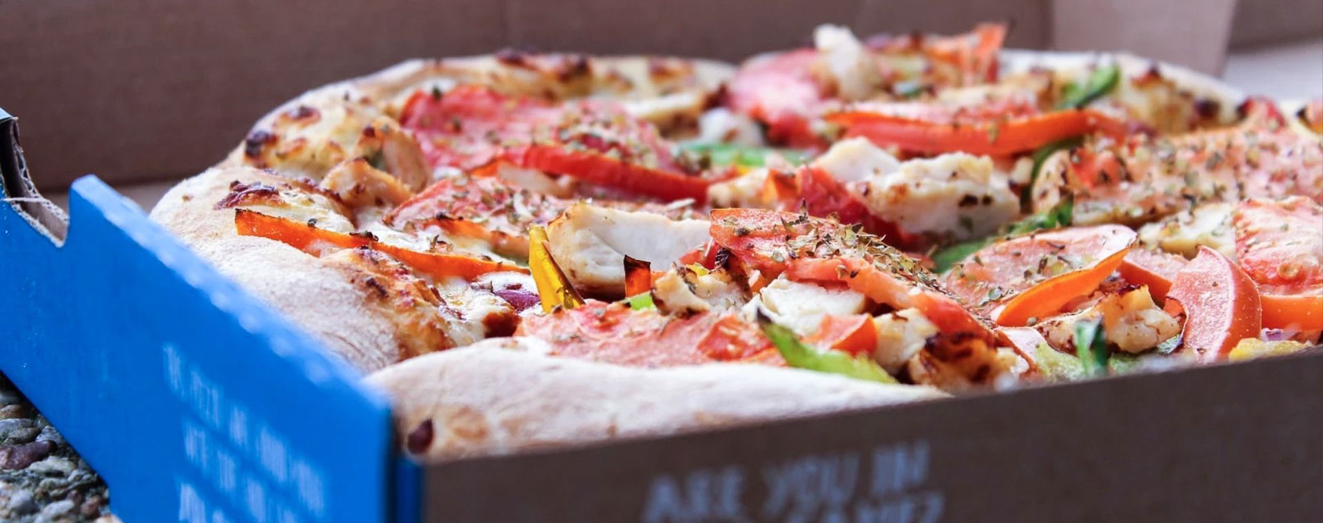 A pizza is sitting in a box on a table.