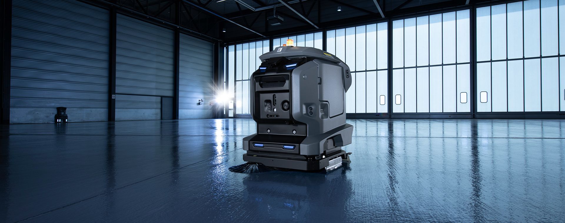 A robot is cleaning the floor of a large building autonomously.