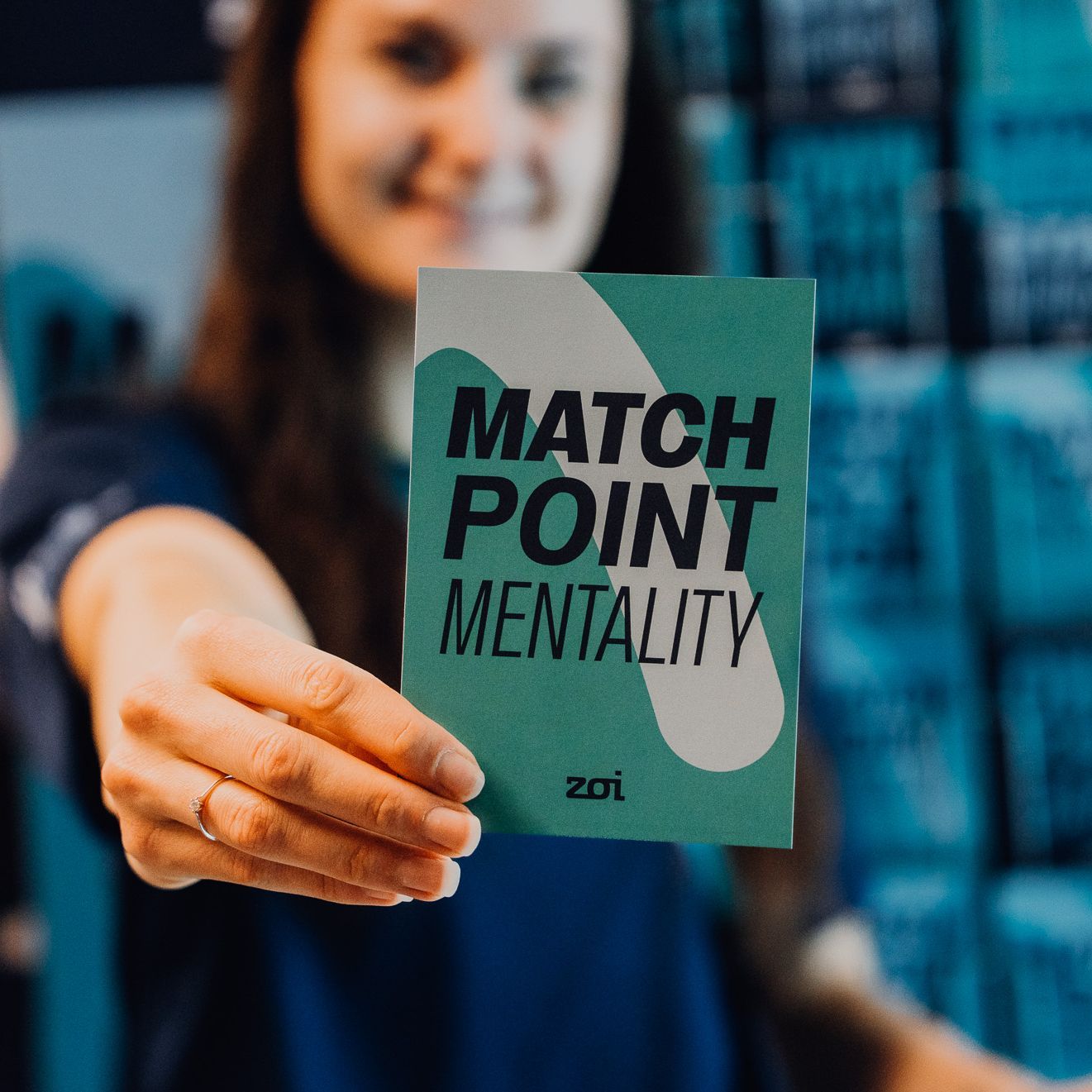 Hand holding a blue card with