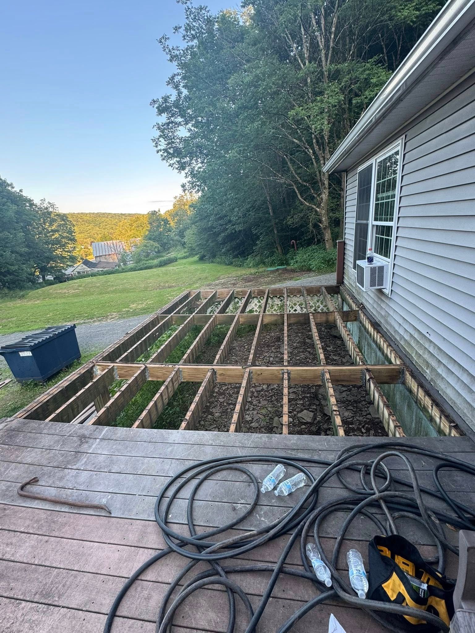 A wooden deck is being built in front of a house.