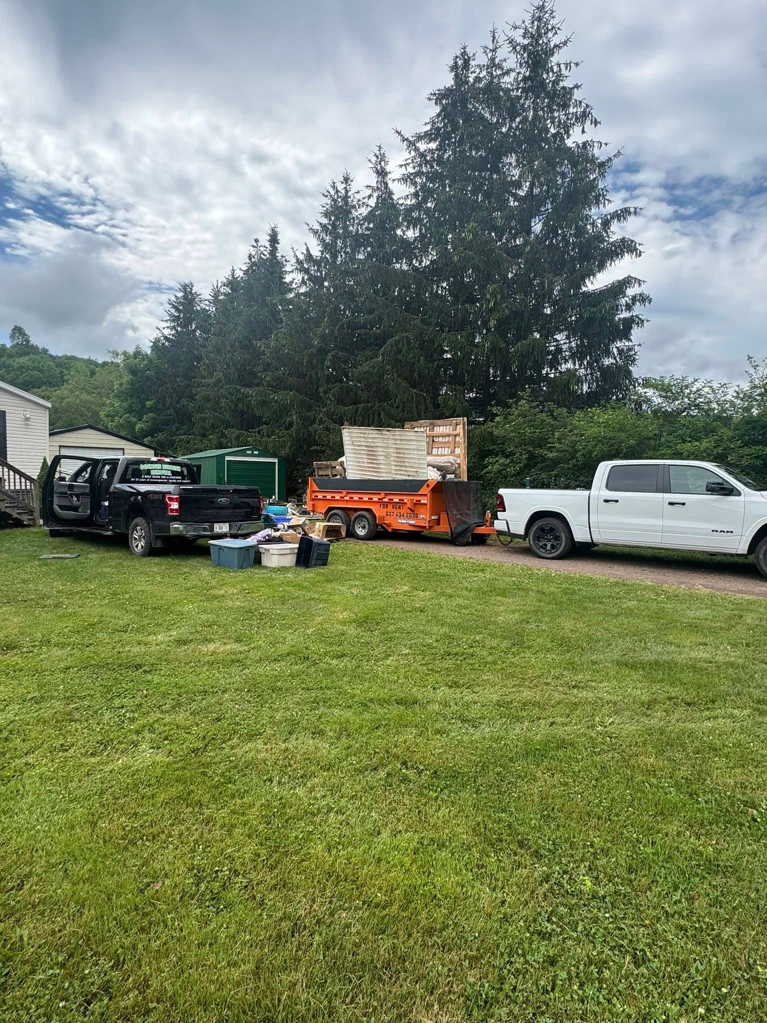 A group of trucks are parked in a grassy field.