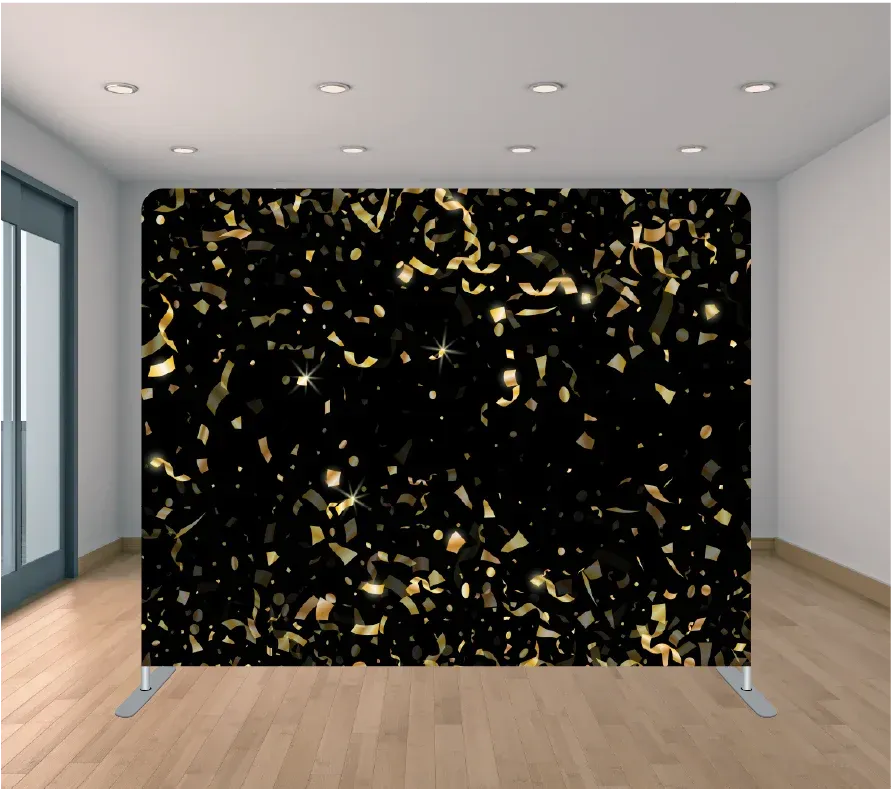 A black and gold confetti backdrop is sitting on a wooden floor in a room.