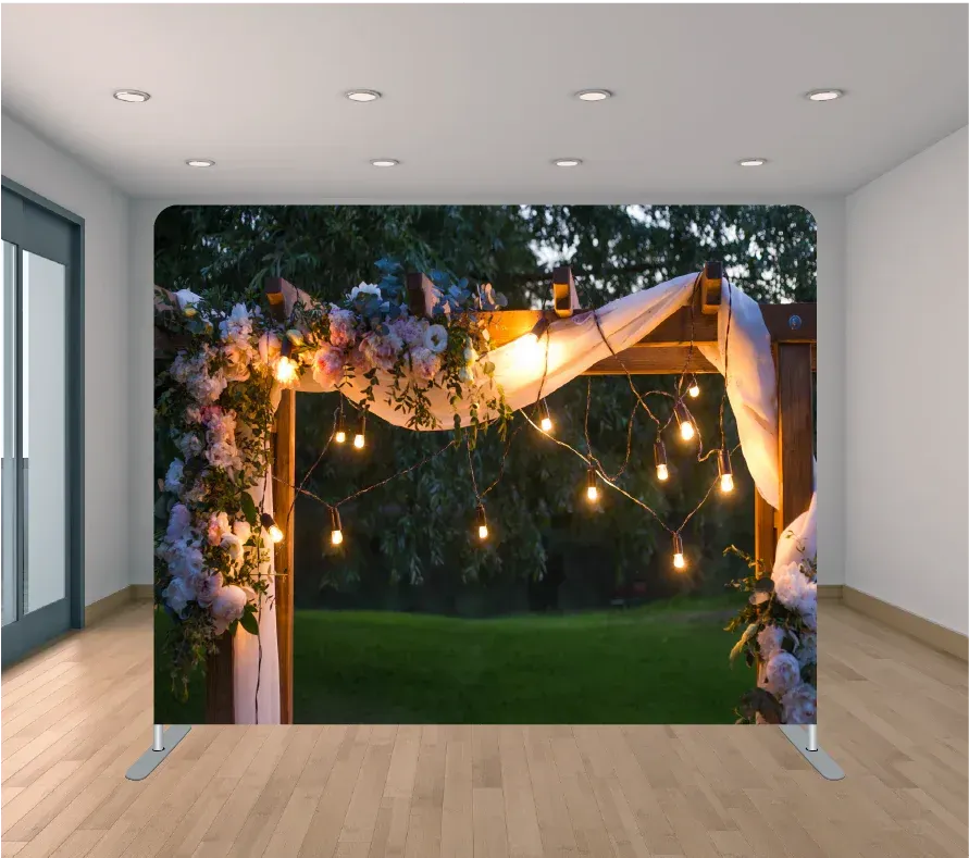 A room with a wooden arch decorated with flowers and lights.