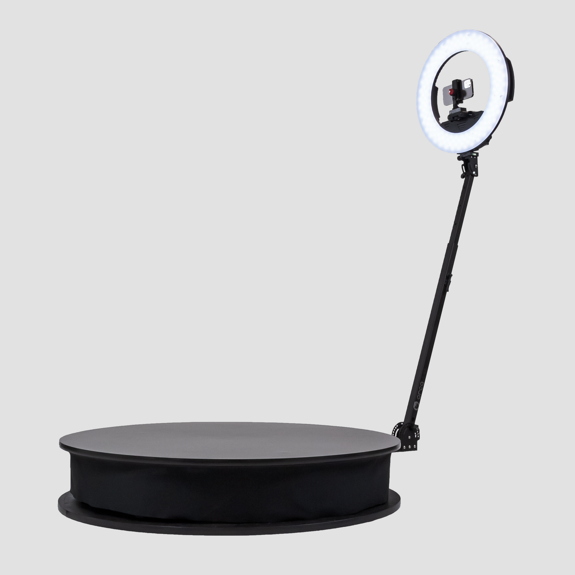 A black turntable with a ring light attached to it.