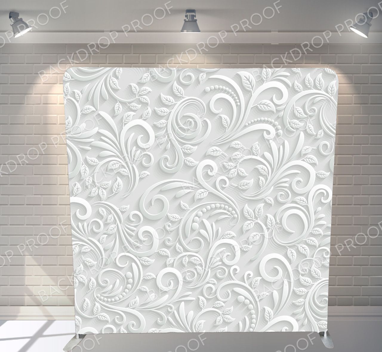 A white wall with a white floral pattern on it.
