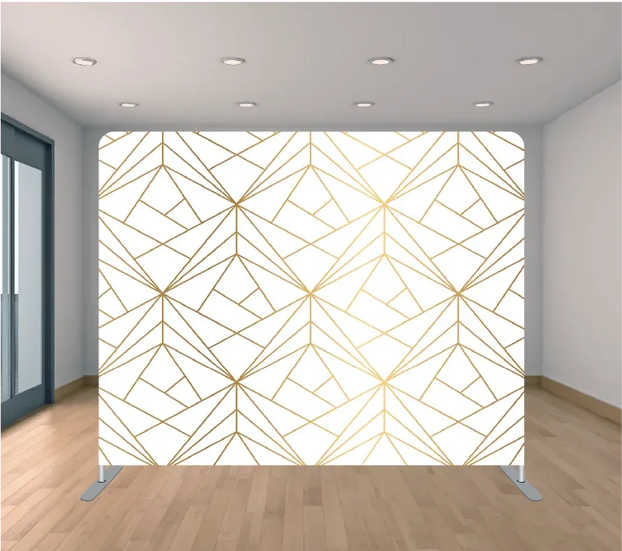 A room with a white wall and a gold geometric pattern on it.