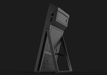 A black object is sitting on a stand on a black background.