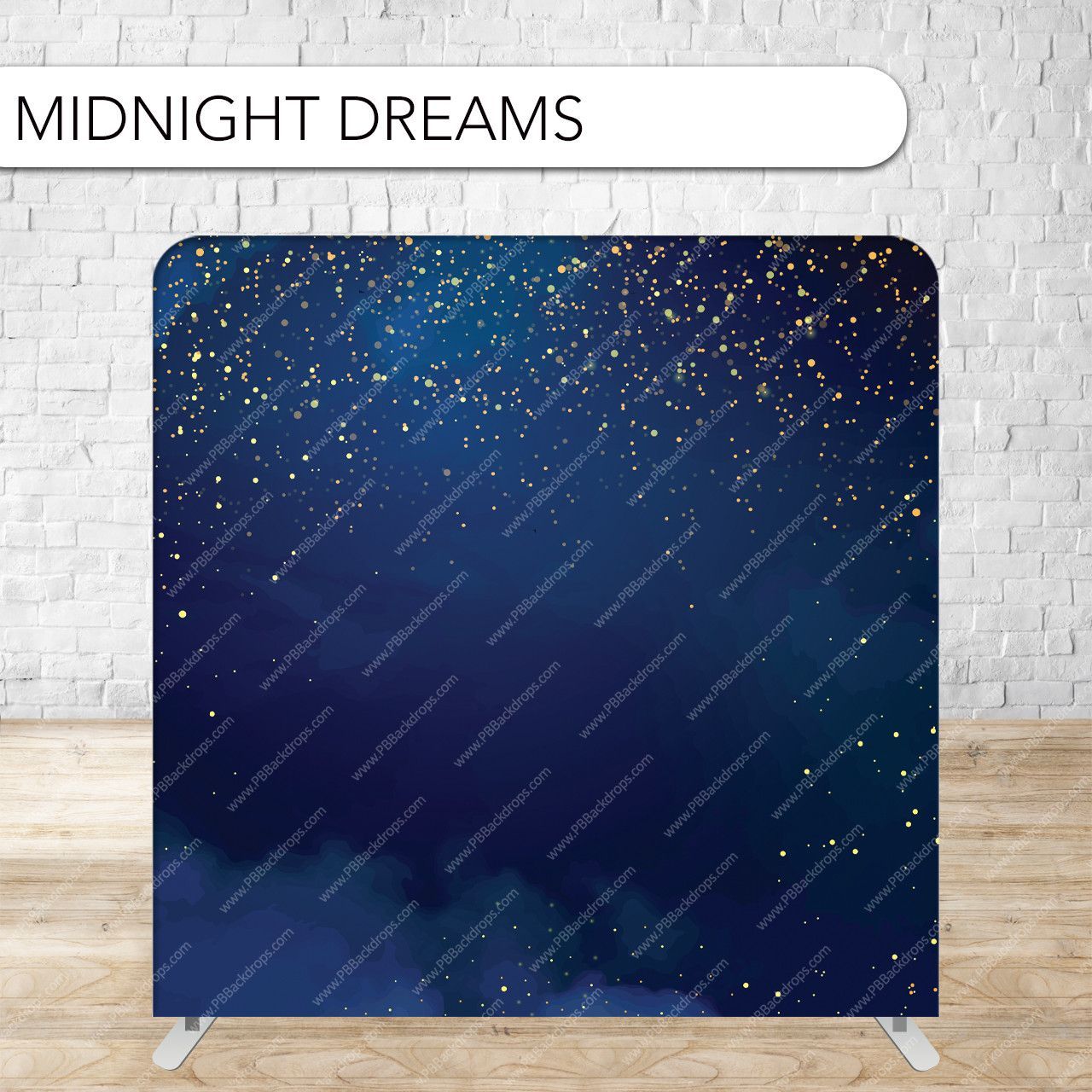 A midnight dreams backdrop is sitting on a wooden floor in front of a brick wall.