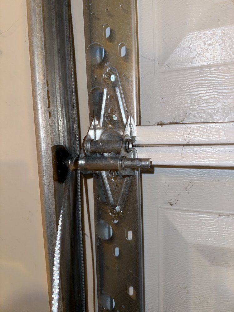 A close up of a garage door with a chain attached to it.