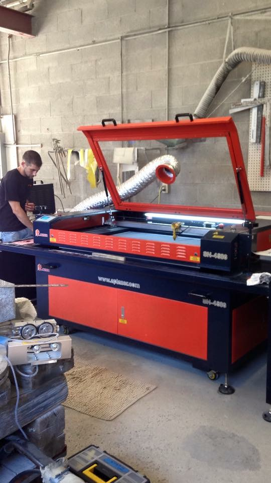 A man is working on a machine in a garage