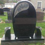 Portsmouth Monument Co. craftsmen working on a custom memorial headstone in the Portsmouth shop